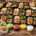 Weekly keto meal prep containers with chicken, roasted vegetables and sugar-free sauces for busy families